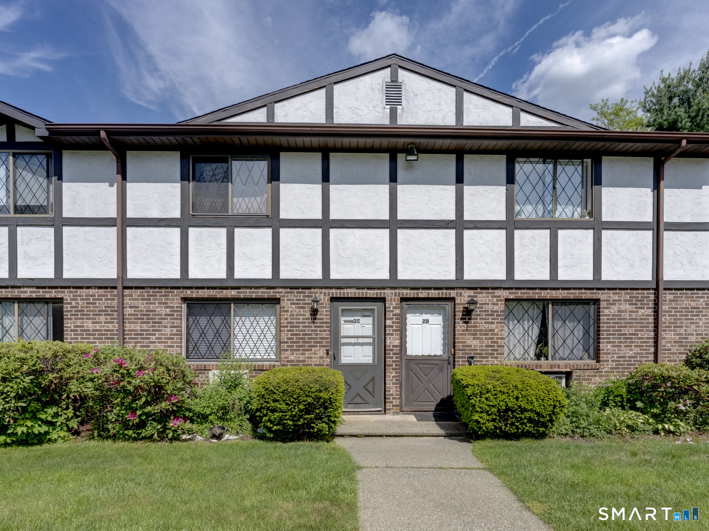 2 Branch Road, Unit 2C Thomaston, CT 06787 - Photo 1 of 26 a front view of a house with a garden