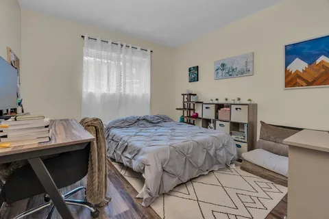 a bedroom with a bed and a table in it