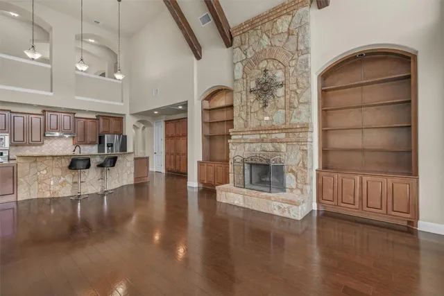 a view of a living room with hardwood floor and a fireplace