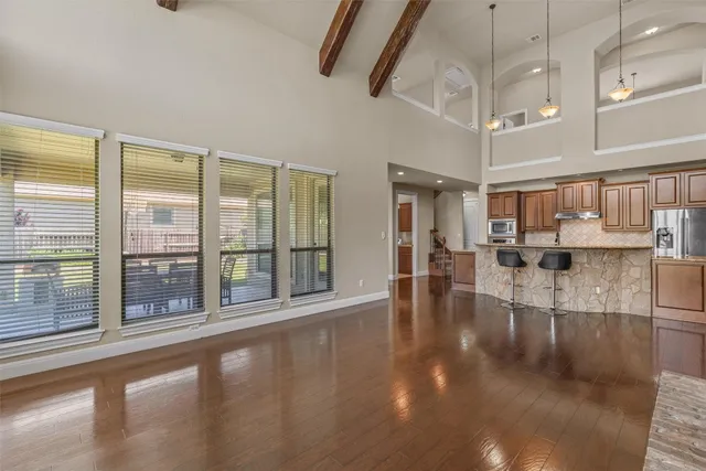 a view of a living room with hardwood floor and a large window