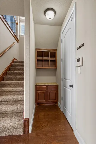 a view of an entryway with table and staircase
