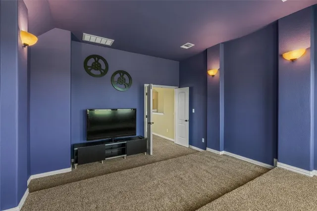 a living room with flat screen tv and a lamp