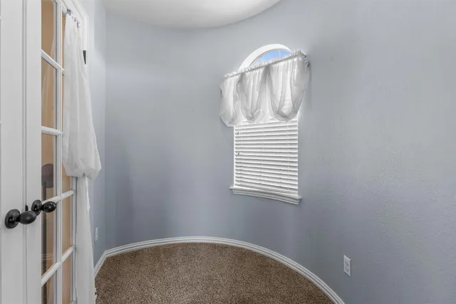 a view of a livingroom with wooden floor and a window