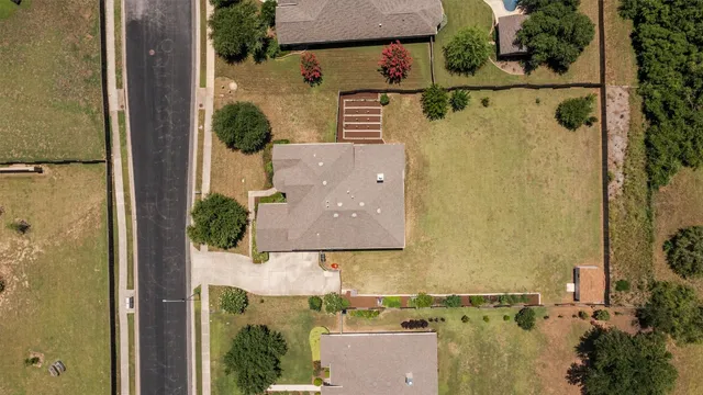 an aerial view of residential houses with outdoor space