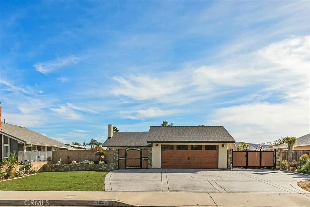 11228 Cameron Drive Riverside, CA 92505 - Photo 1 of 28 a front view of a house with a garden