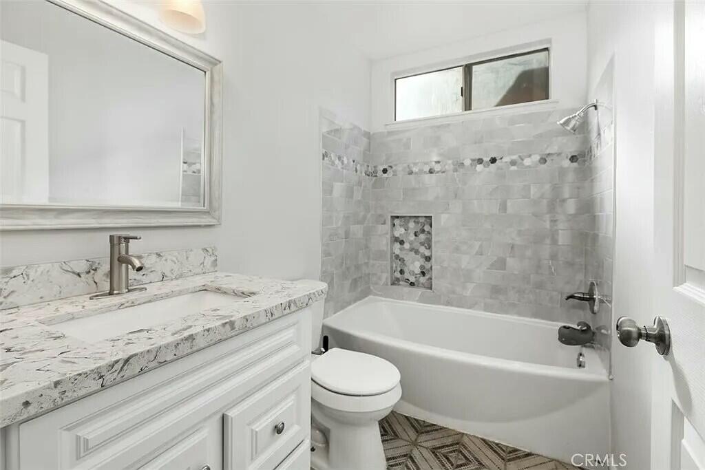 11228 Cameron Drive Riverside, CA 92505 - Photo 12 of 28 a bathroom with a granite countertop sink toilet and shower