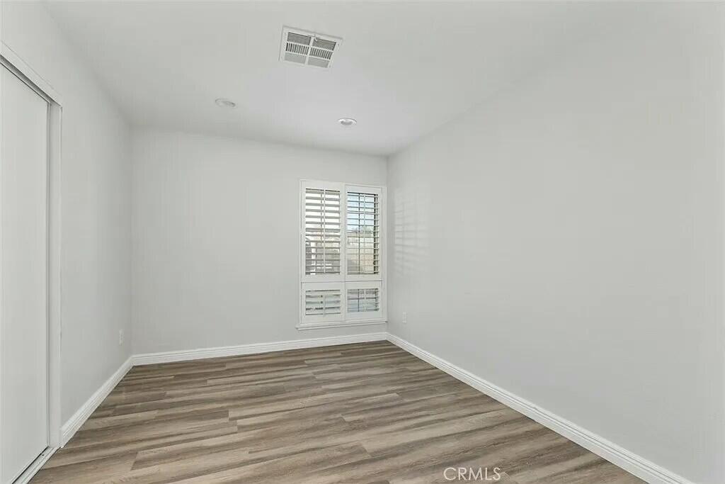 11228 Cameron Drive Riverside, CA 92505 - Photo 13 of 28 a view of an empty room with wooden floor and a window