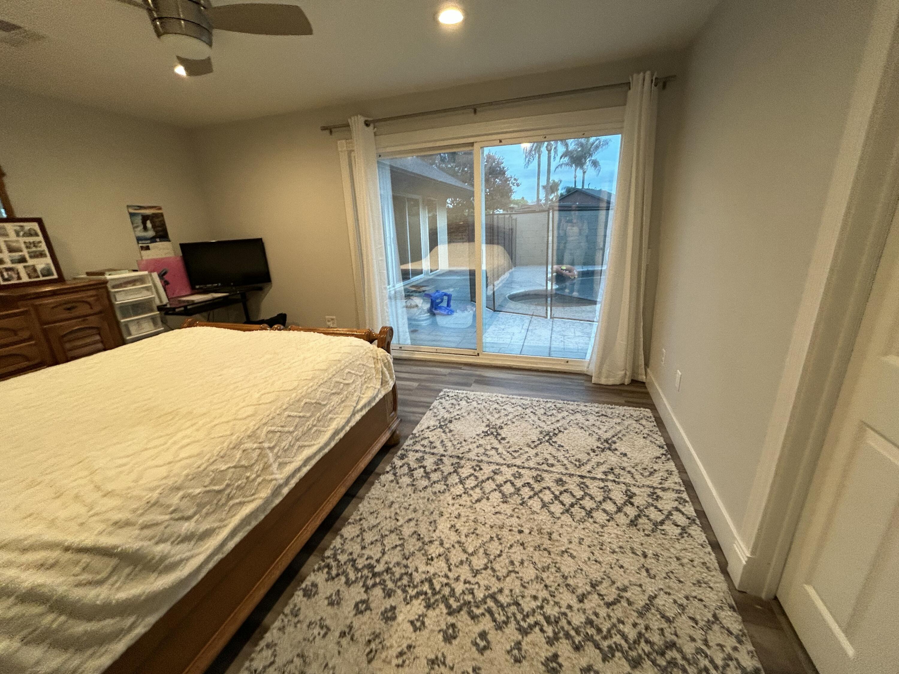 11228 Cameron Drive Riverside, CA 92505 - Photo 19 of 28 a bedroom with a bed and wooden floor