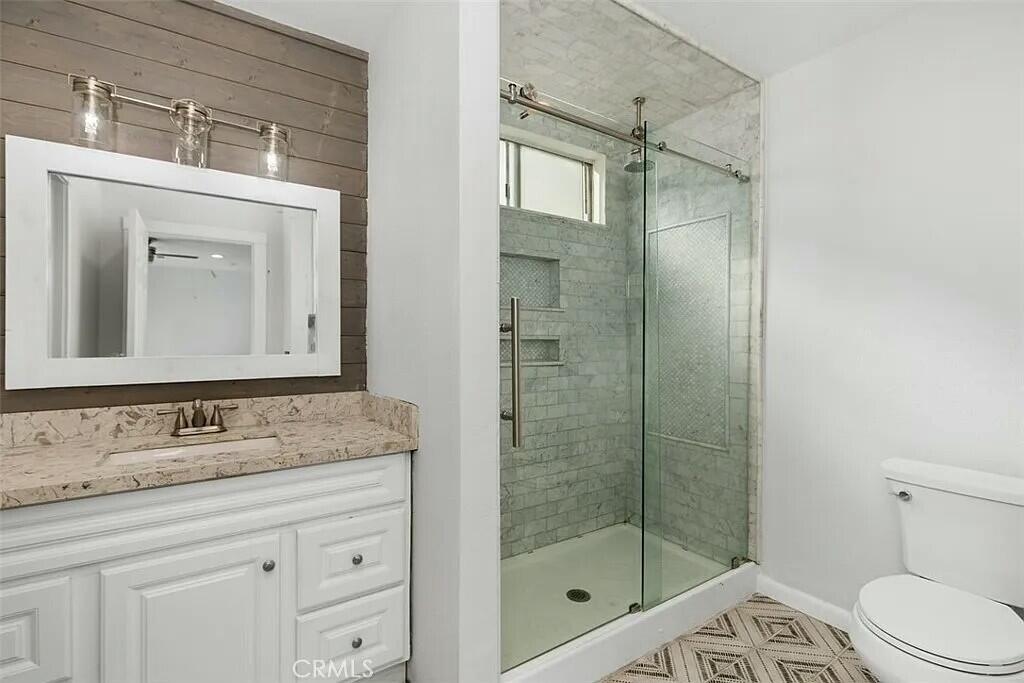 11228 Cameron Drive Riverside, CA 92505 - Photo 20 of 28 a bathroom with a shower sink vanity and mirror