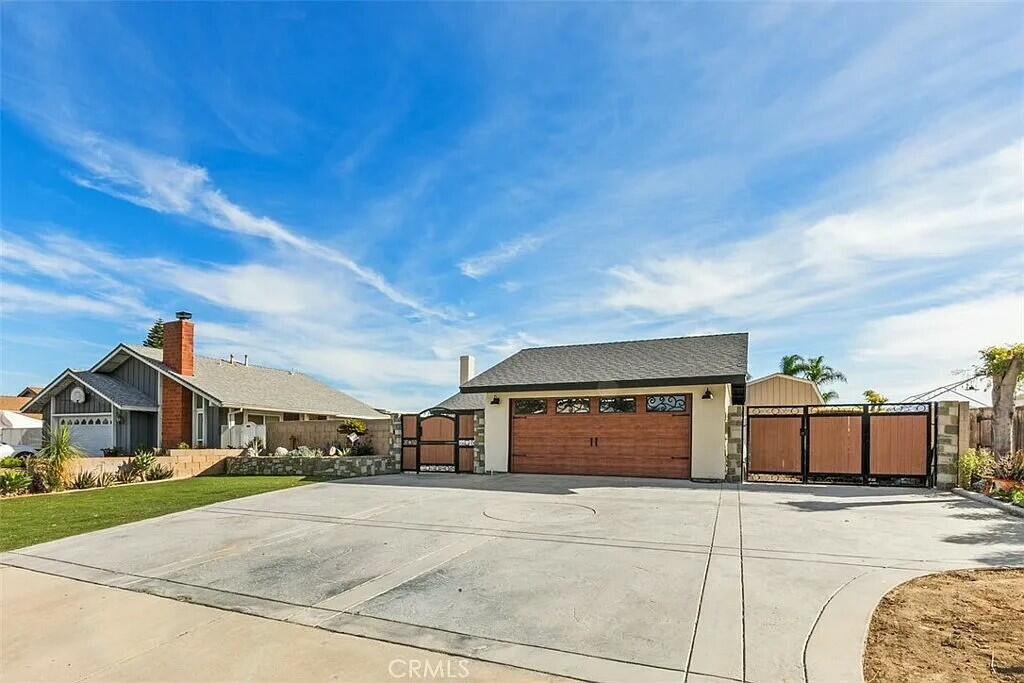 11228 Cameron Drive Riverside, CA 92505 - Photo 3 of 28 a front view of a house with a yard and garage