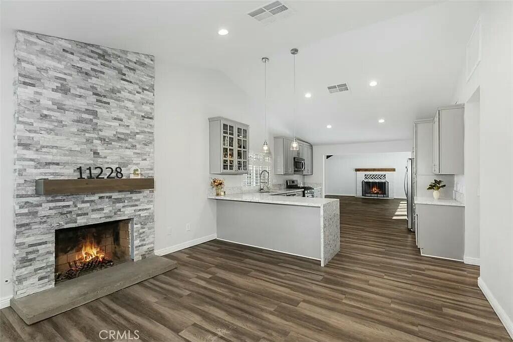 11228 Cameron Drive Riverside, CA 92505 - Photo 4 of 28 a view of a kitchen with a sink a fireplace and a window