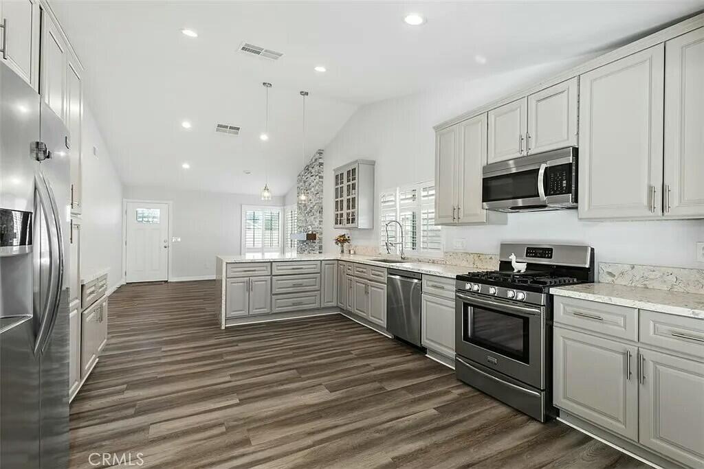 11228 Cameron Drive Riverside, CA 92505 - Photo 6 of 28 a large kitchen with stainless steel appliances granite countertop a stove and a sink