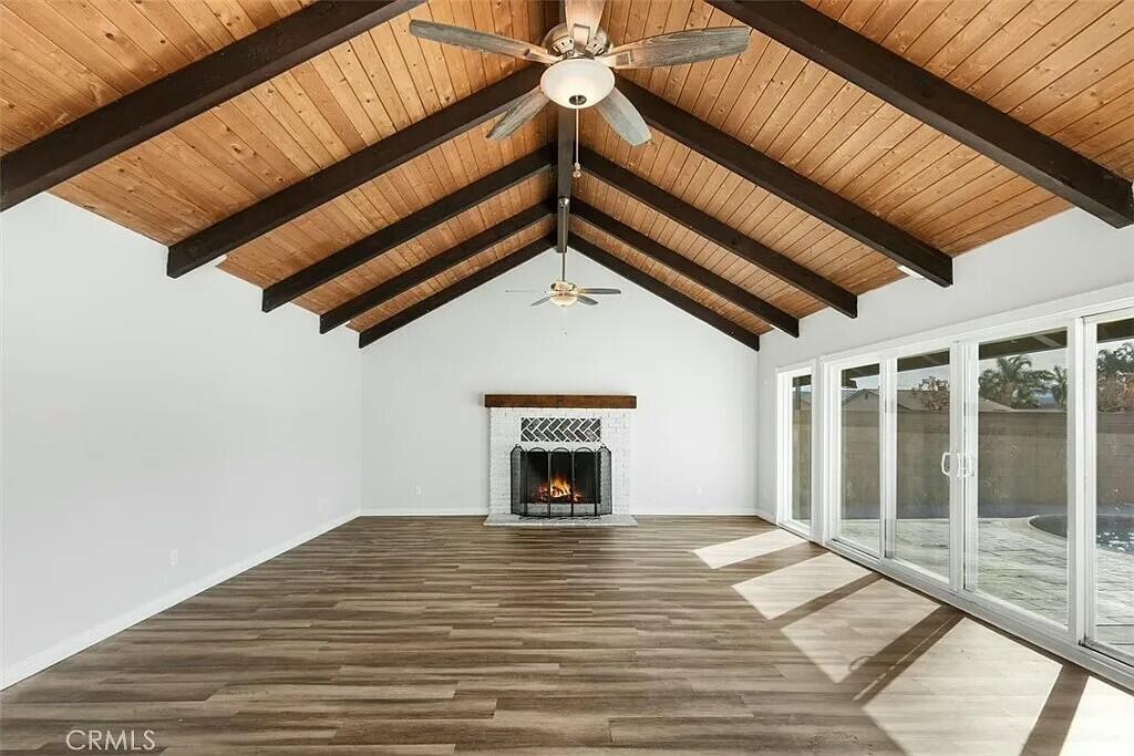 11228 Cameron Drive Riverside, CA 92505 - Photo 9 of 28 a view of an empty room with wooden floor and a fireplace