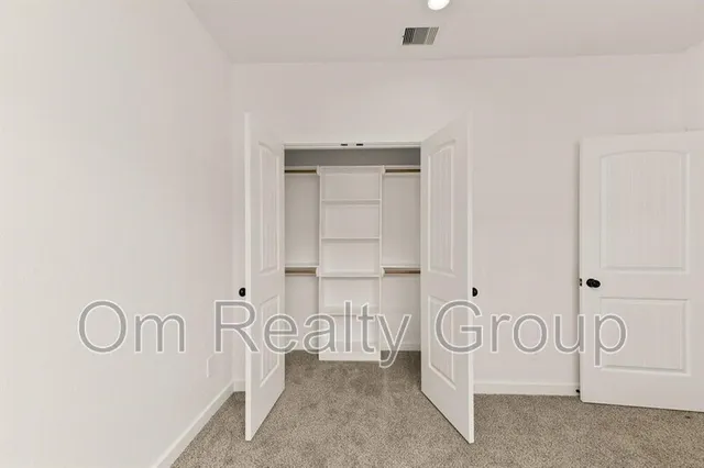a view of a room with white cabinets