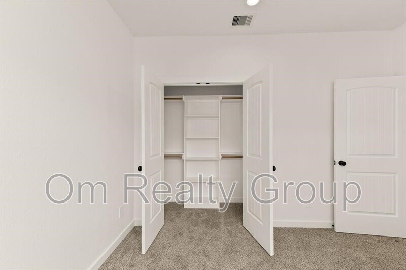 a view of a room with white cabinets