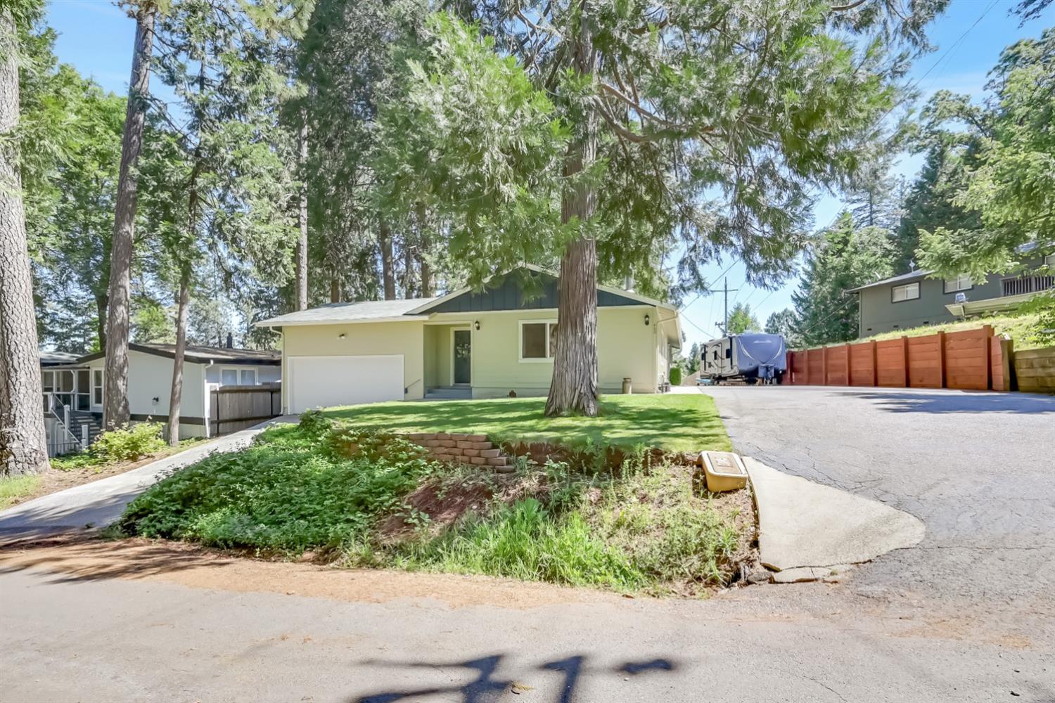 460 Alpine Drive Colfax, CA 95713 - Photo 1 of 1 a front view of a house with a yard and garage