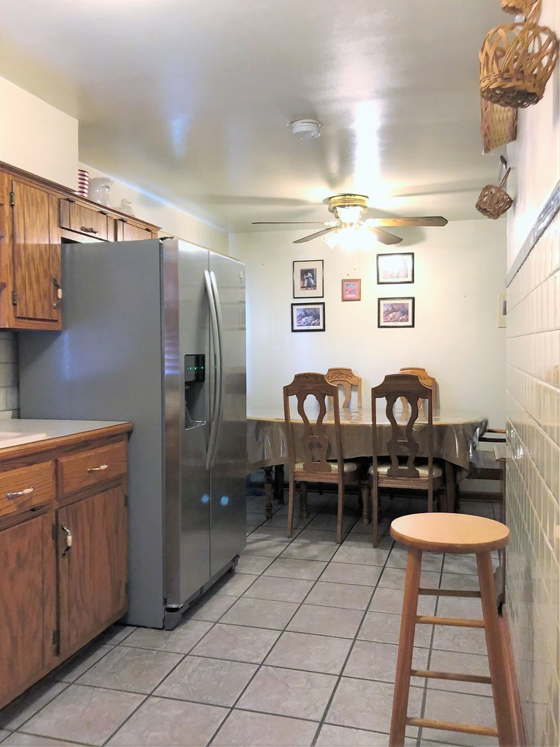 715 Water Street Joliet, IL 60436 - Photo 11 of 21 a spacious bathroom with a granite countertop sink and a mirror