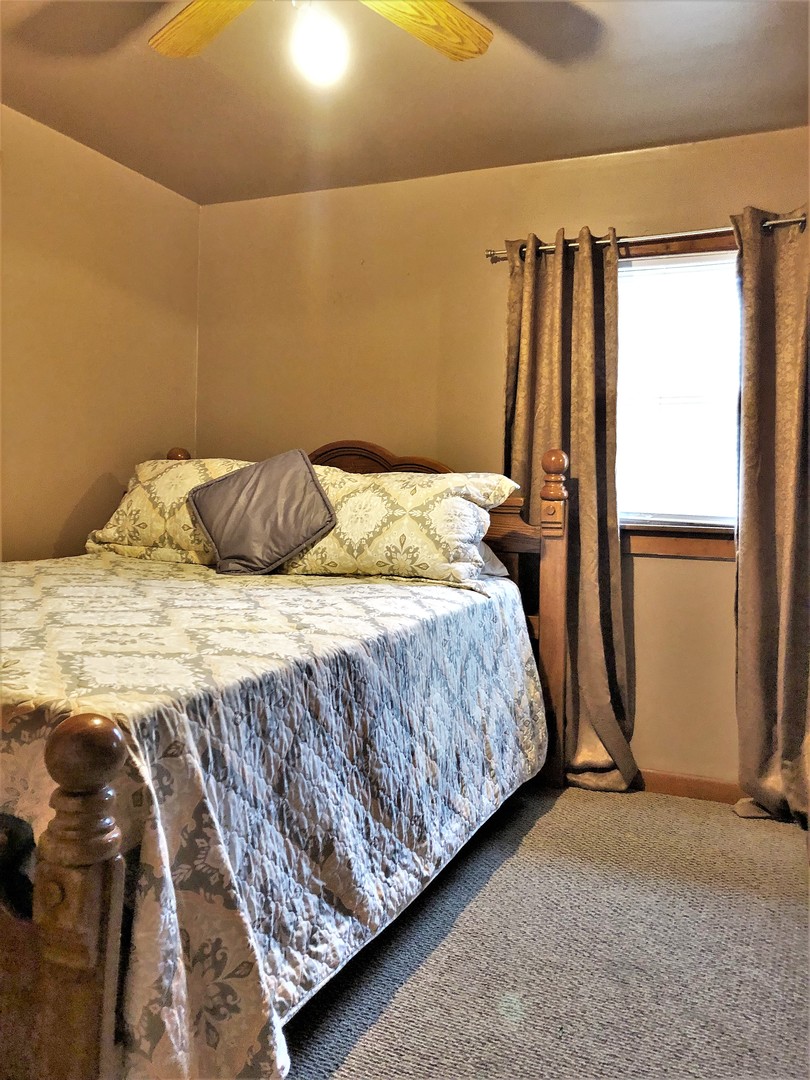 715 Water Street Joliet, IL 60436 - Photo 15 of 21 a bedroom with a bed and a window