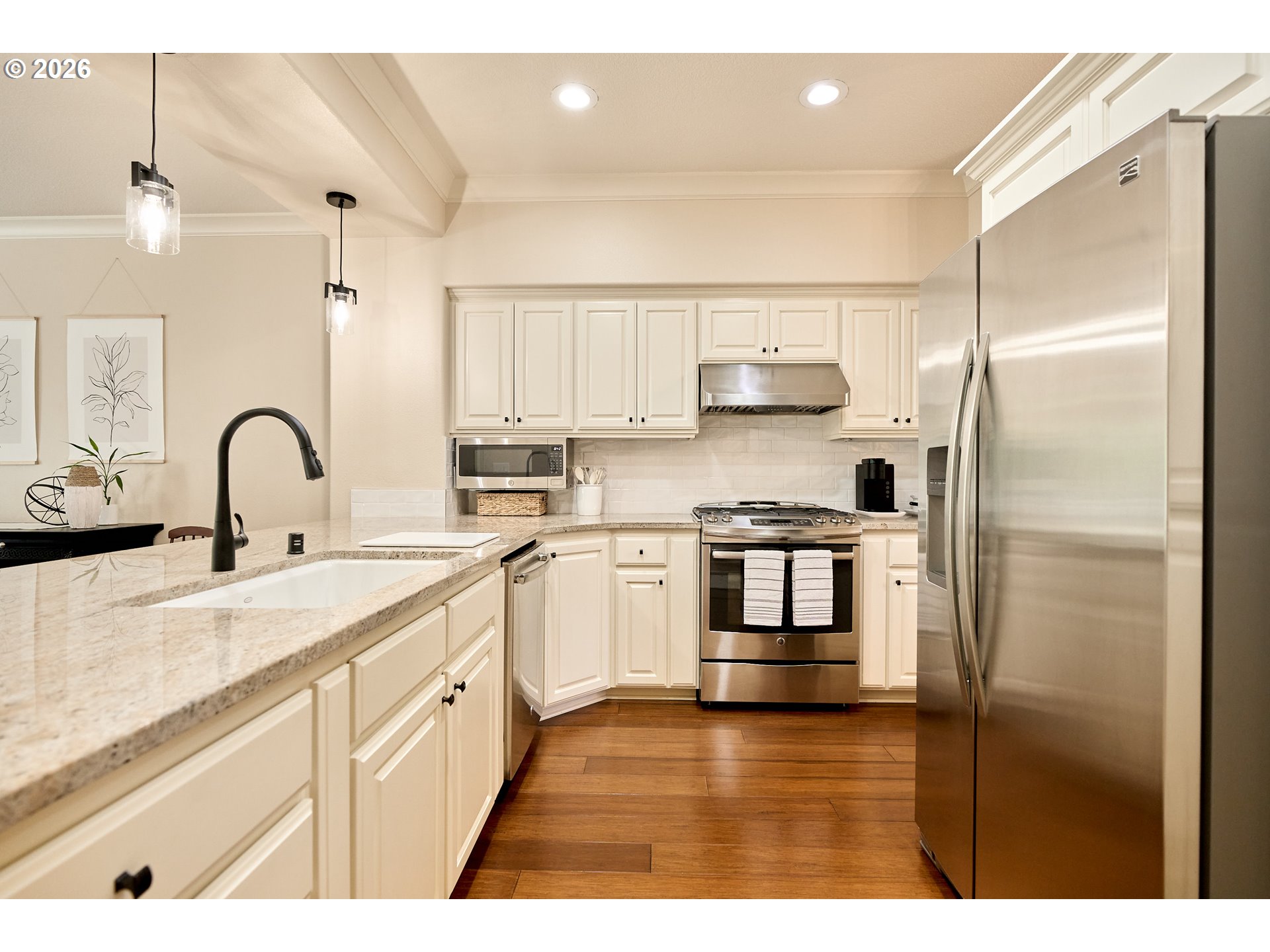 2120 Northwest Fargo Loop Camas, WA 98607 - Photo 21 of 42 a kitchen with kitchen island white cabinets and stainless steel appliances