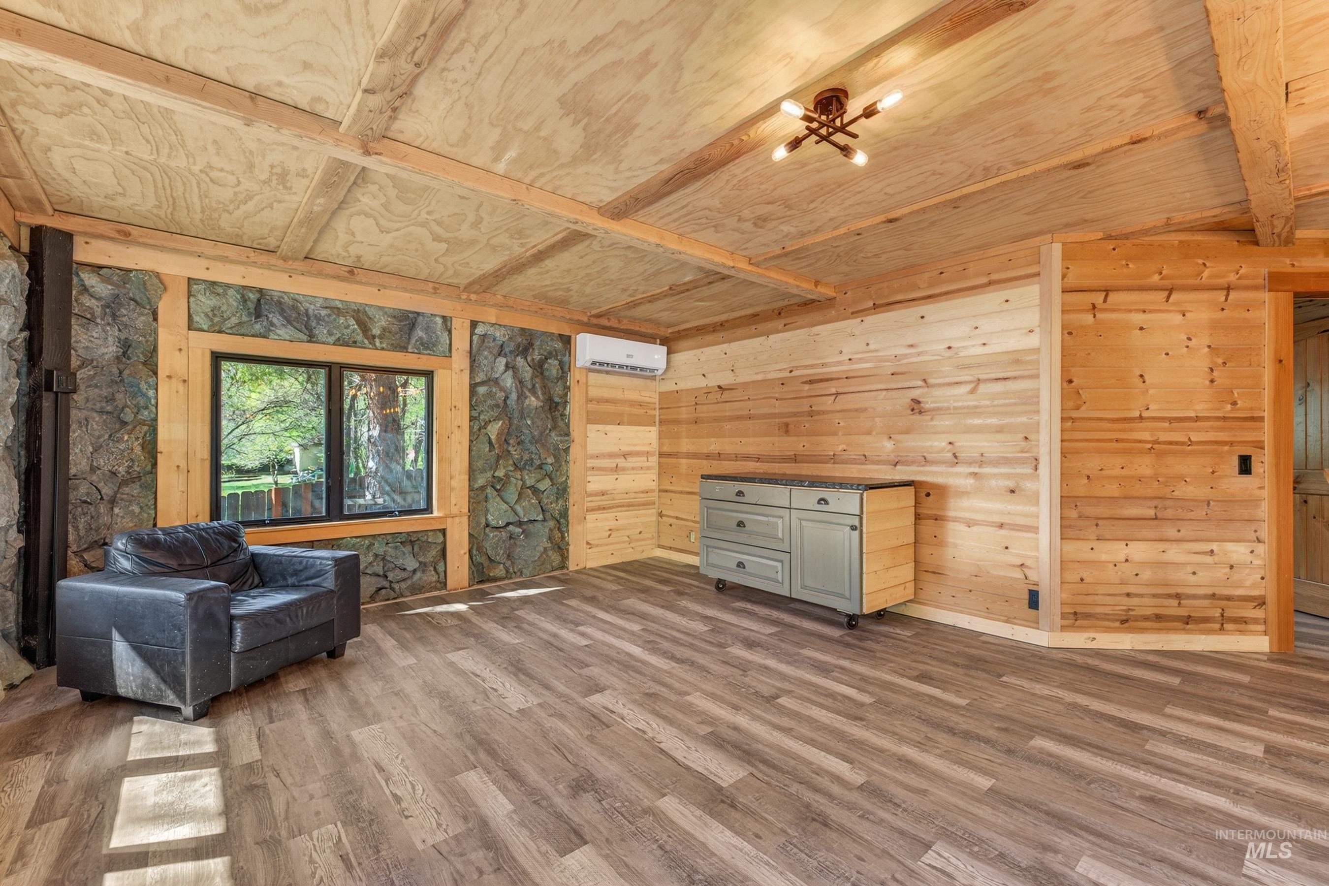 543 North Main Street Riggins, ID 83549 - Photo 14 of 46 Living area featuring wood walls, beam ceiling, and wood finished floors