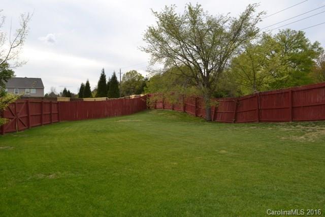 408 Lafinca Court Fort Mill, SC 29708 - Photo 19 of 20 a view of yard with swimming pool and wooden fence
