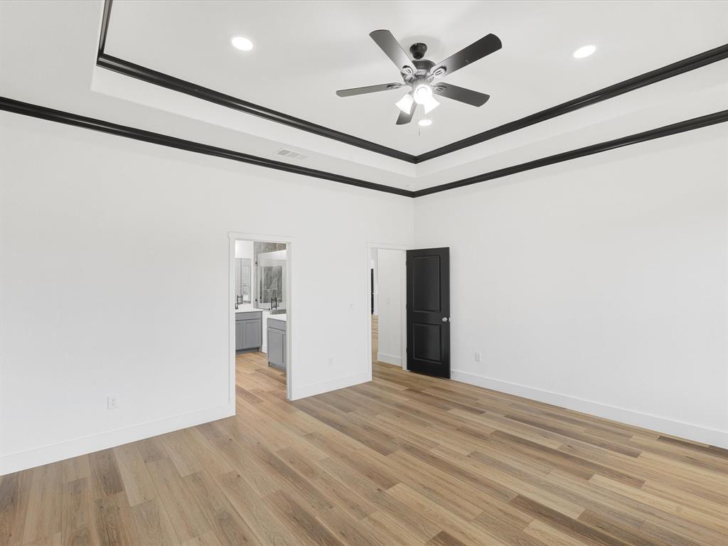 544 Shepherd Road Combine, TX 75159 - Photo 21 of 36 a view of a big room with wooden floor and a ceiling fan