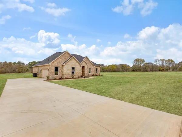a view of a house with yard and lake view