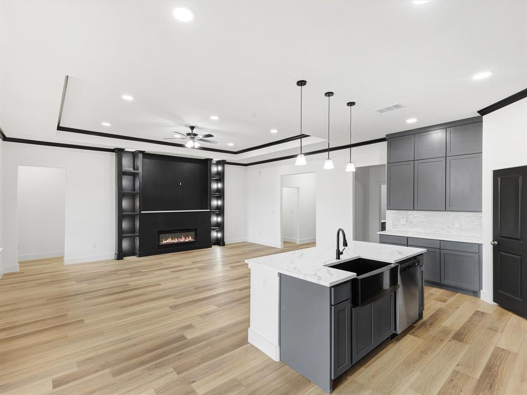 544 Shepherd Road Combine, TX 75159 - Photo 36 of 36 a kitchen with kitchen island a sink and a stove with wooden floor