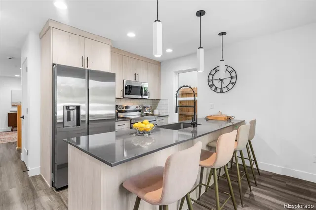 a kitchen with a table chairs and refrigerator