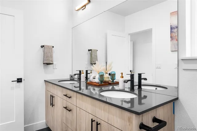 a bathroom with a granite countertop sink and a mirror