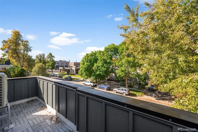 a view of balcony with wooden floor and fence