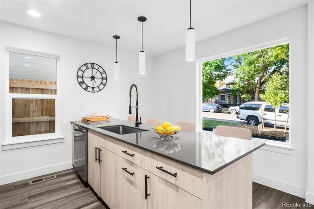 a kitchen with a table a stove and a window