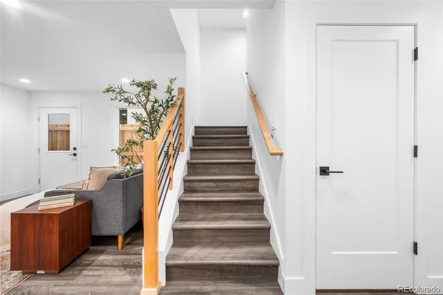 a view of entryway and hall with wooden floor