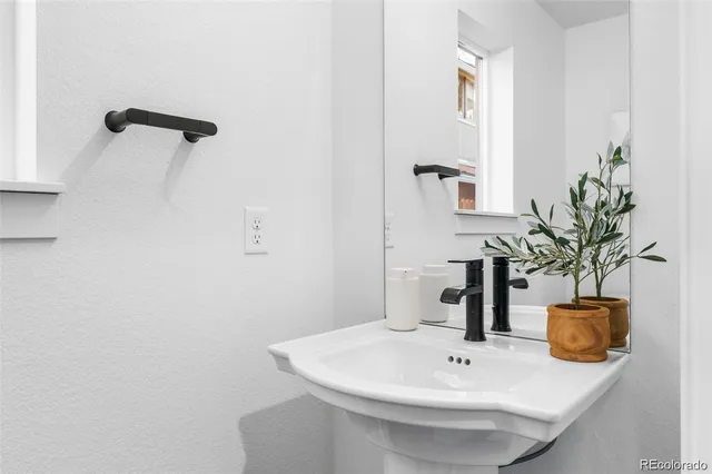 a bathroom with a sink a mirror and a