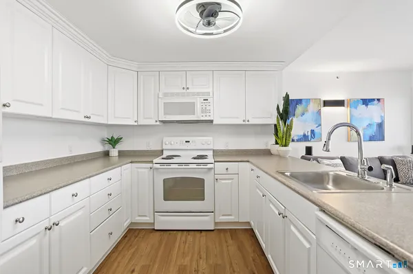 a kitchen with cabinets a sink and appliances