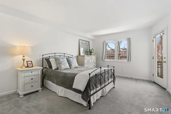 a spacious bedroom with a bed and a window