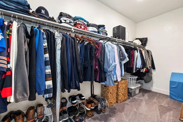 a spacious bedroom with a bed and a chandelier
