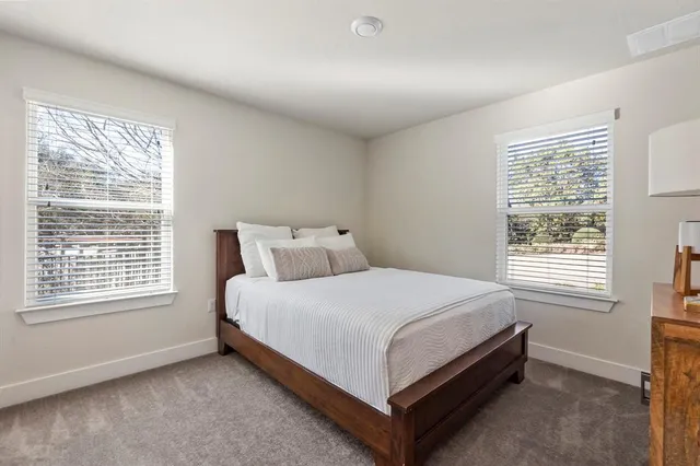 a bathroom with a sink a toilet and a large mirror