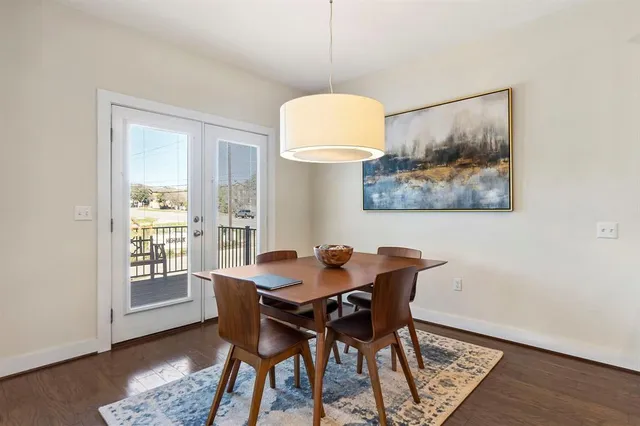 a view of a dining room with furniture wooden floor and a window