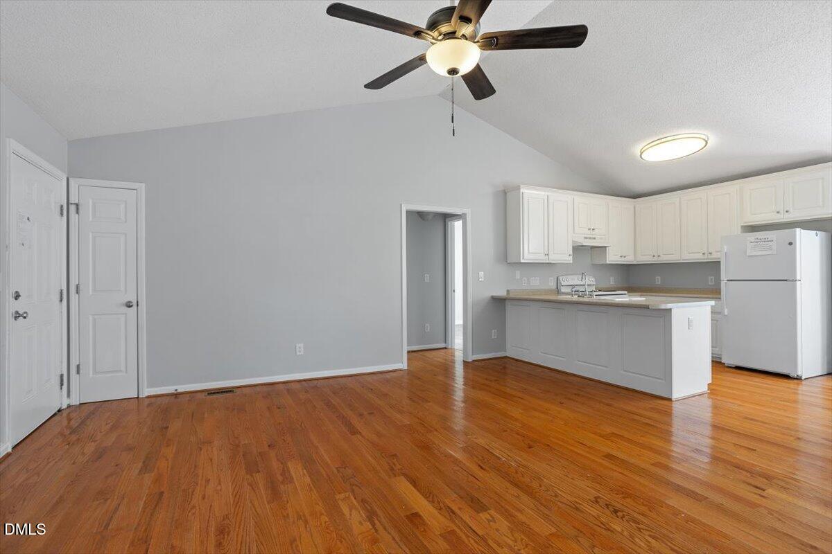 1084 McLemore Road Clayton, NC 27520 - Photo 11 of 34 a view of kitchen with cabinets appliances and wooden floor