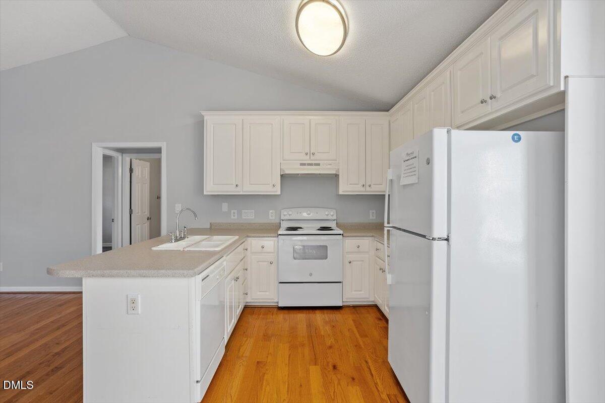 1084 McLemore Road Clayton, NC 27520 - Photo 16 of 34 a kitchen with a refrigerator a stove top oven a sink and dishwasher