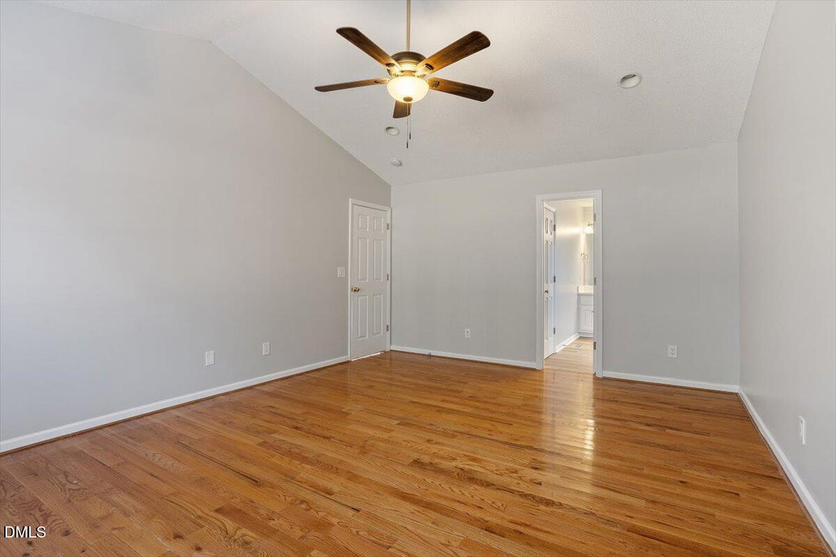 1084 McLemore Road Clayton, NC 27520 - Photo 22 of 34 a view of an empty room with window and a ceiling fan