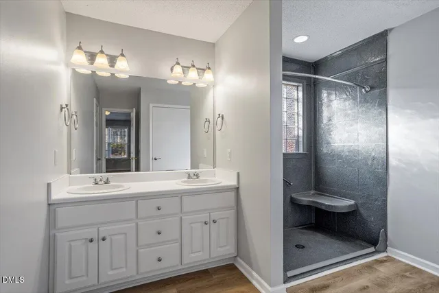 a bathroom with a double vanity sink and a mirror