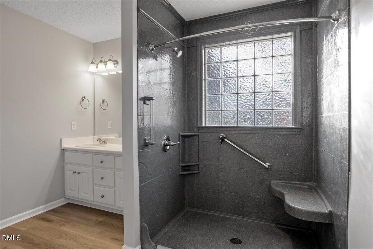 1084 McLemore Road Clayton, NC 27520 - Photo 25 of 34 a bathroom with a sink a toilet and shower