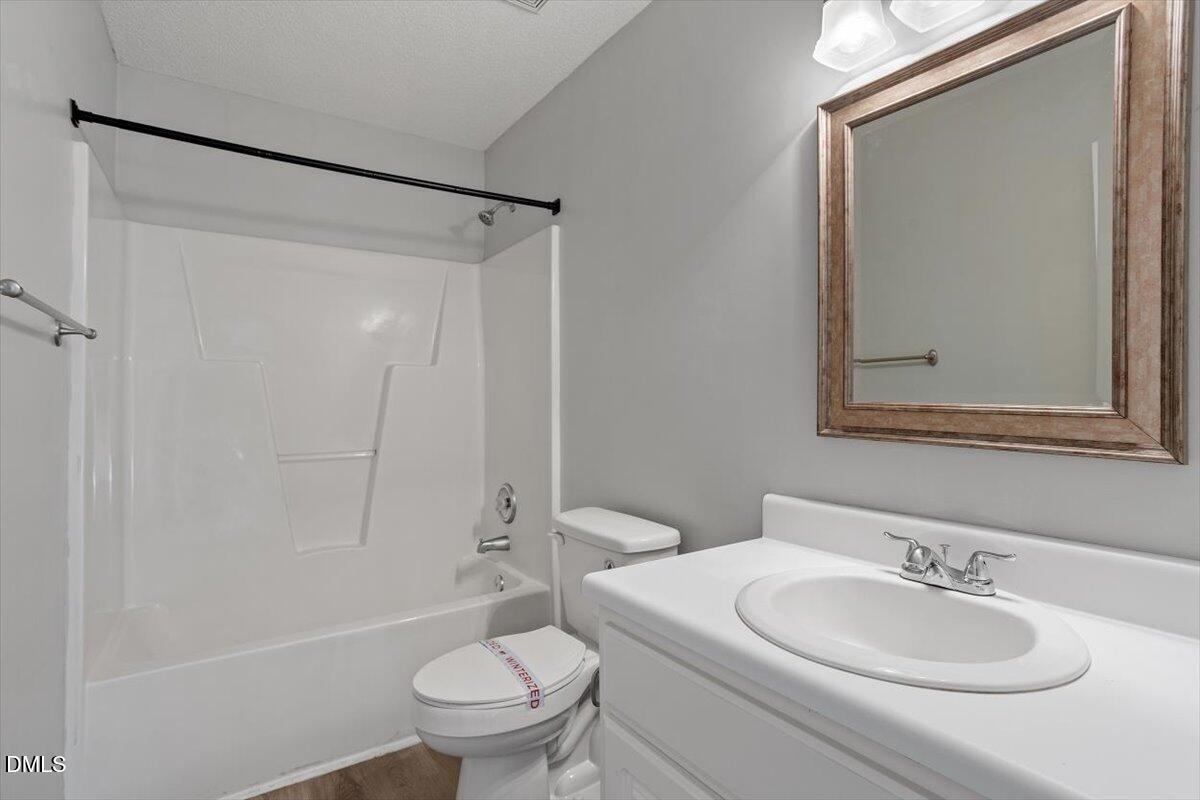 1084 McLemore Road Clayton, NC 27520 - Photo 28 of 34 a bathroom with a sink toilet and shower