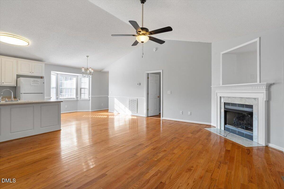 1084 McLemore Road Clayton, NC 27520 - Photo 7 of 34 a view of empty room with wooden floor and fireplace