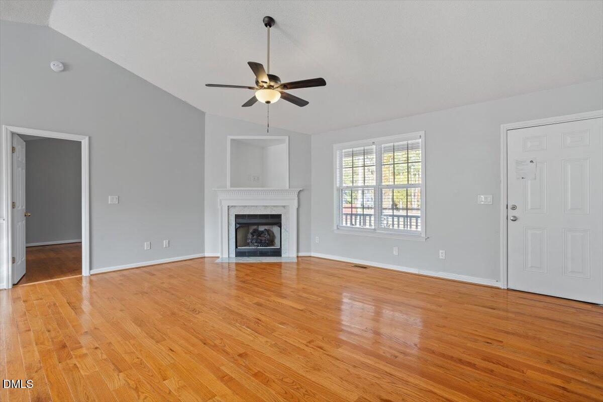 1084 McLemore Road Clayton, NC 27520 - Photo 8 of 34 a view of empty room with wooden floor and fan