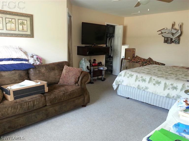 1569 Meadow Road Lehigh Acres, FL 33976 - Photo 10 of 19 a living room with furniture and a flat screen tv