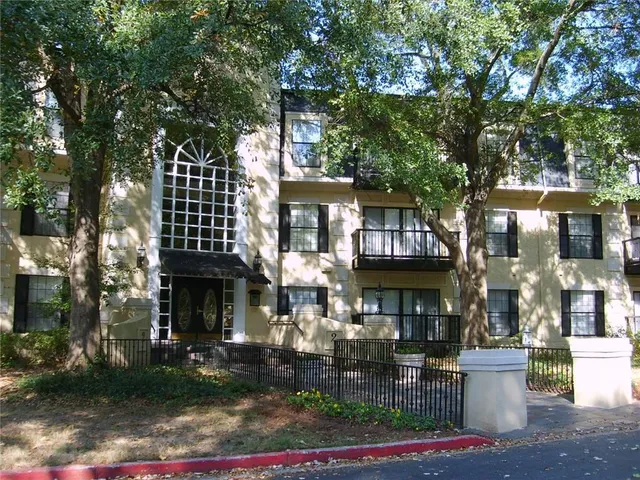 a front view of a house with a tree