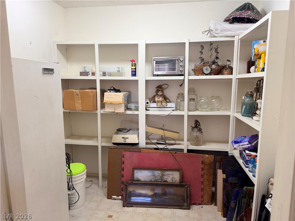 1391 West Dyer Road Pahrump, NV 89048 - Photo 30 of 50 Functional pantry space with ample built-in shelving provides abundant storage opportunities.